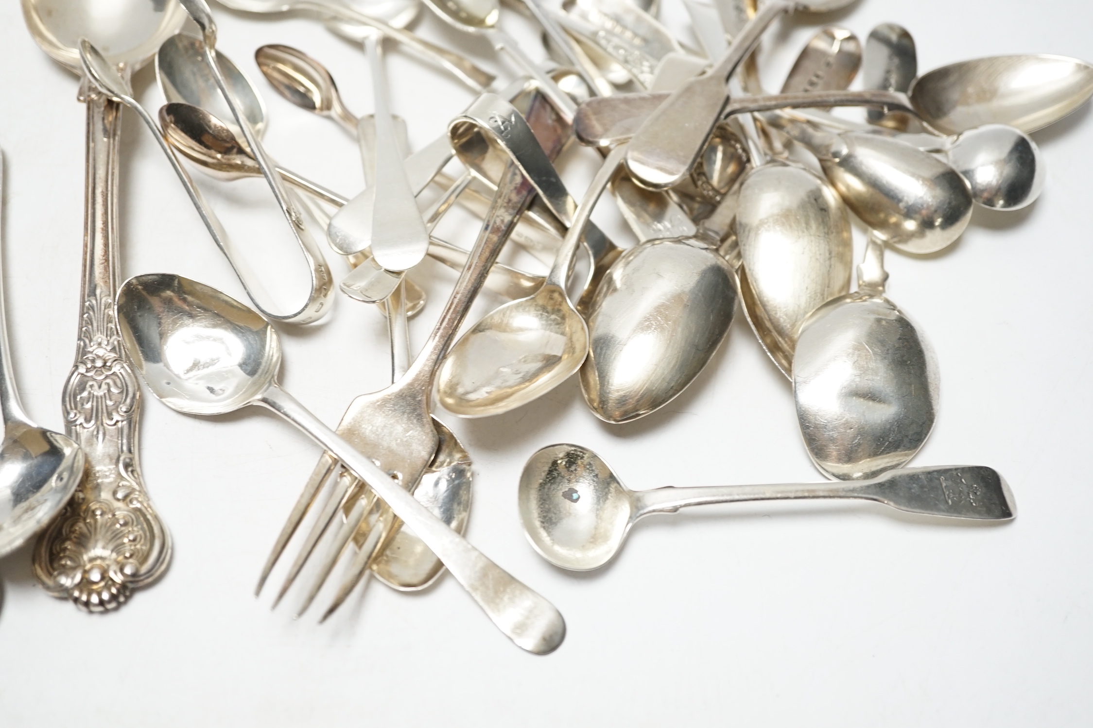 Sundry silver cutlery, including a pair of Victorian Kings pattern table forks and a matching tablespoon, London, 1845, a William IV fiddle pattern sauce ladle and various salt, tea and coffee spoons, 21.9oz and three pl